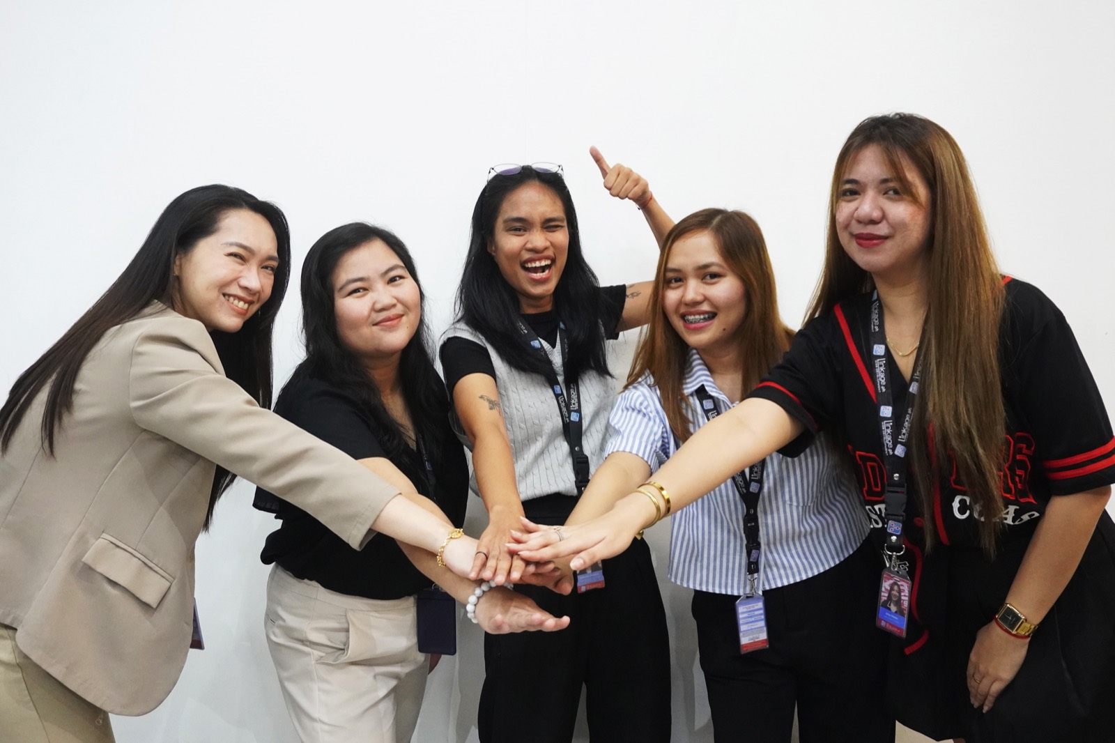 The Linkage team putting their hands in together